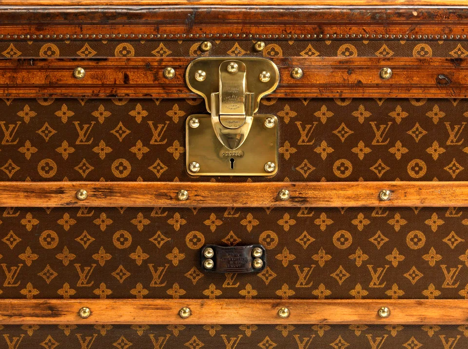 The Louis Vuitton monogram began life as an anti-counterfeit patented trademark, as seen in this 1906 low trunk.