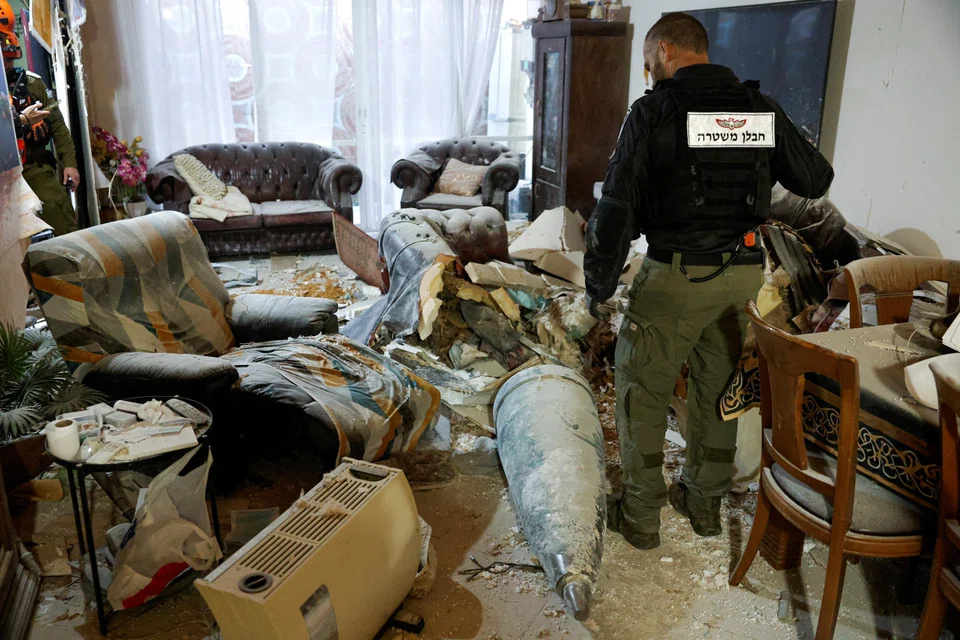 An Iranian missile fragment in a living room in Israel, following a barrage launched towards the country on Mar 20.