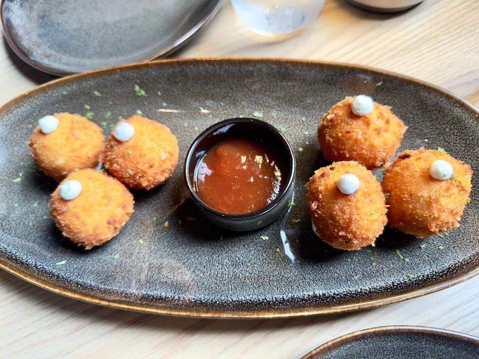 Grana padano cheese balls are served with a sweet tomato jam.