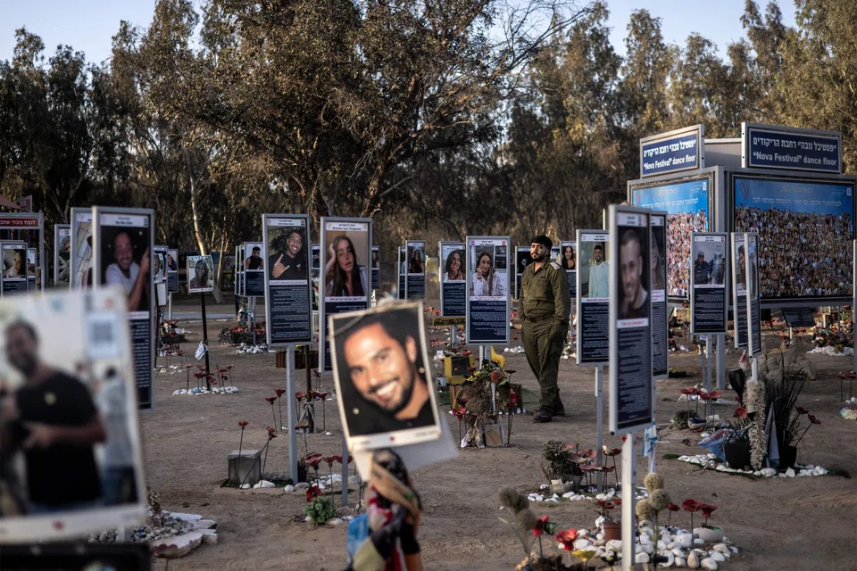 An Israeli army soldier walks past the memorials of victims of the Oct 7, 2023 attacks at the Nova Festival grounds in Reim in southern Israel on Oct 6, 2025, a day before the attacks' second anniversary. Hamas' October 2023 attack resulted in the deaths of 1,219 people, mostly civilians, according to an AFP tally of Israeli official figures. 