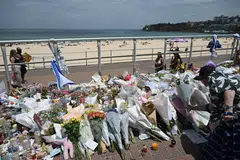 People continue to bring flowers to the Bondi Beach promenade as crowds return to Bondi Beach in Sydney, Australia, Dec 21, 2025.  
