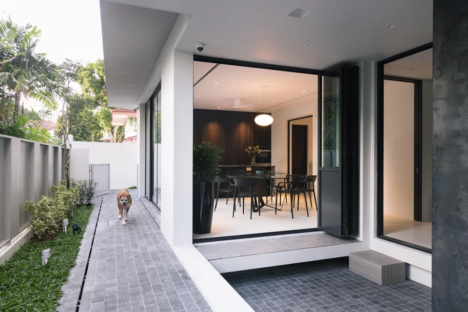 The family's boxer likes to relax in the sunken courtyard just outside the dining room.