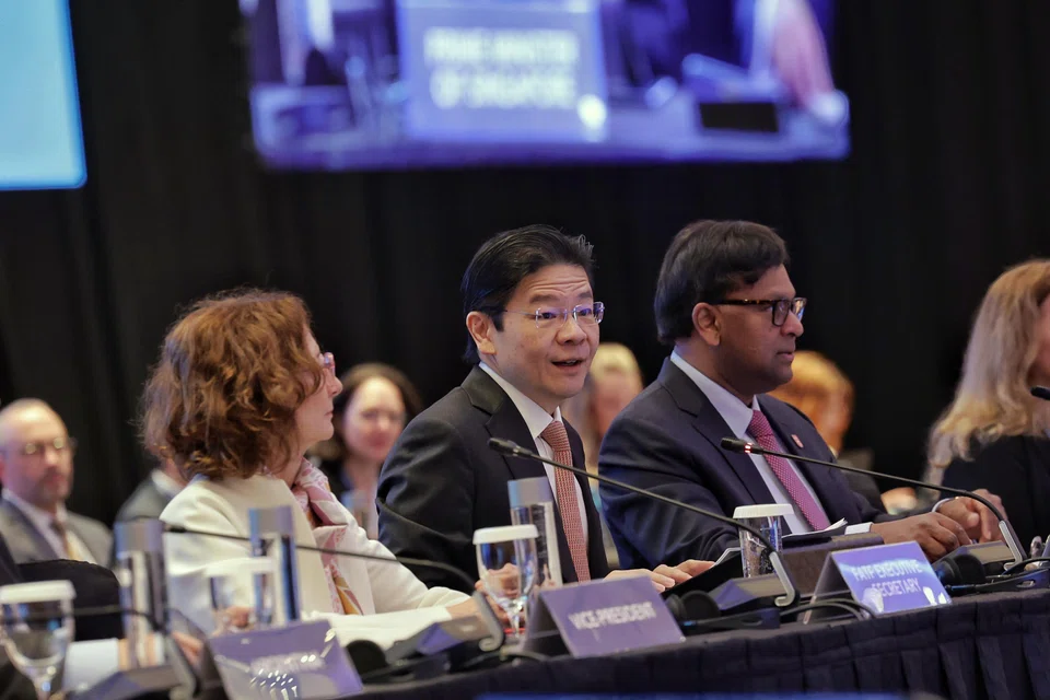 Prime Minister Lawrence Wong speaking at the Financial Action Task Force Plenary in Singapore on Jun 26. With him are (from left) Financial Action Task Force executive secretary Violaine Clerc and president T Raja Kumar.