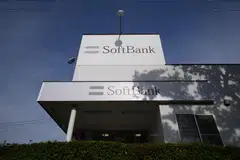 The forecast downgrades are seen by analysts as being partially offset by a stronger yen and the continued rise in the share price of SoftBank’s telecommunications holdings.