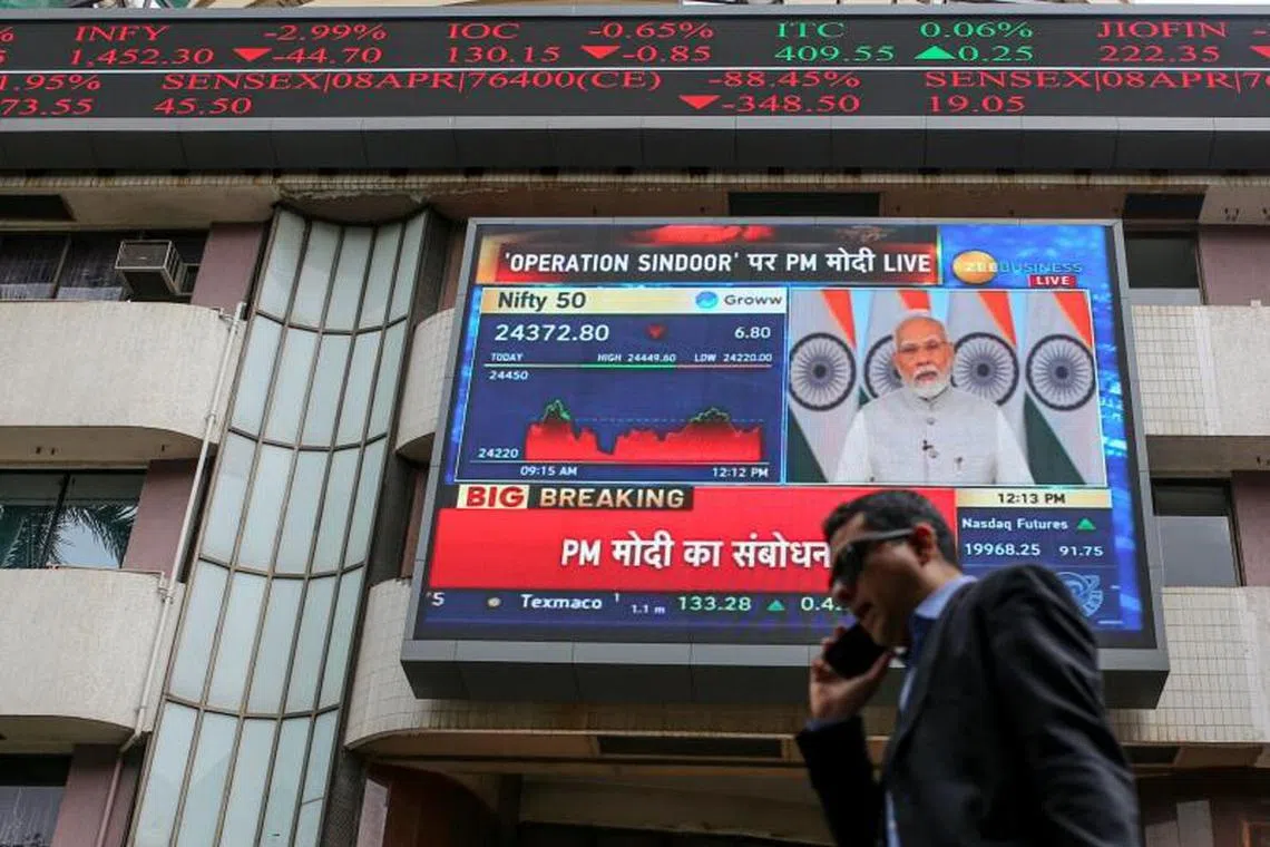 A news broadcast featuring Indian Prime Minister Narendra Modi displayed outside the Bombay Stock Exchange building in Mumbai.