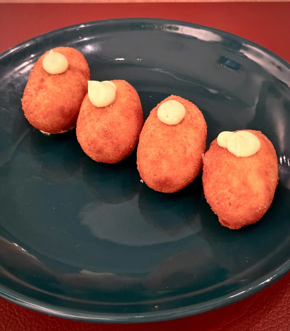 Jamon iberico croquetas are stuffed with thick bechamel filling studded with ham bits.