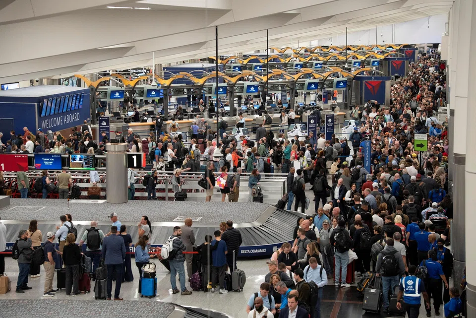 Passengers wait in lines near a TSA checkpoint at Hartsfield-Jackson Atlanta International Airport in Atlanta, Georgia, March 23, 2026. 