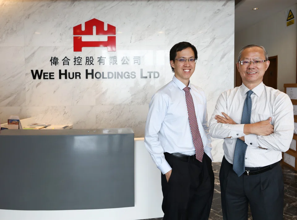 Goh Wee Ping (left, with his father Goh Yeow Lian) managed to find a new investor for the group's student accommodation property trust.