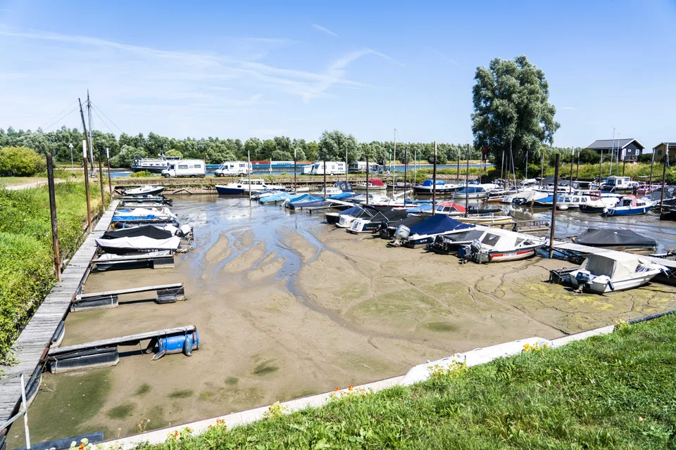 Boats are lying in the mud in the harbour in Beusichem, the Netherlands, 03 August 2022. The Netherlands declared an official water shortage on Wednesday (Aug 3) as the low-lying “land of water” was hit by Europe’s sweltering summer.