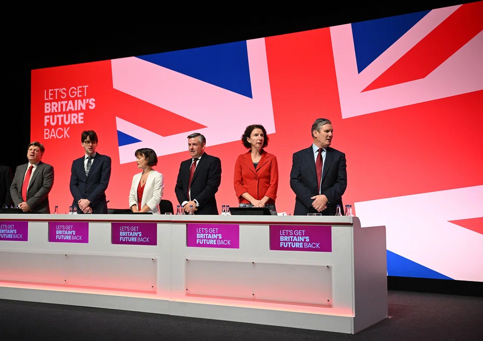 Britain's opposition Labour Party leader Keir Starmer (right) stands with members of the his shadow cabinet, to sing 'Jerusalem' on the final day of the annual Labour Party conference in Liverpool, Oct 11, 2023.