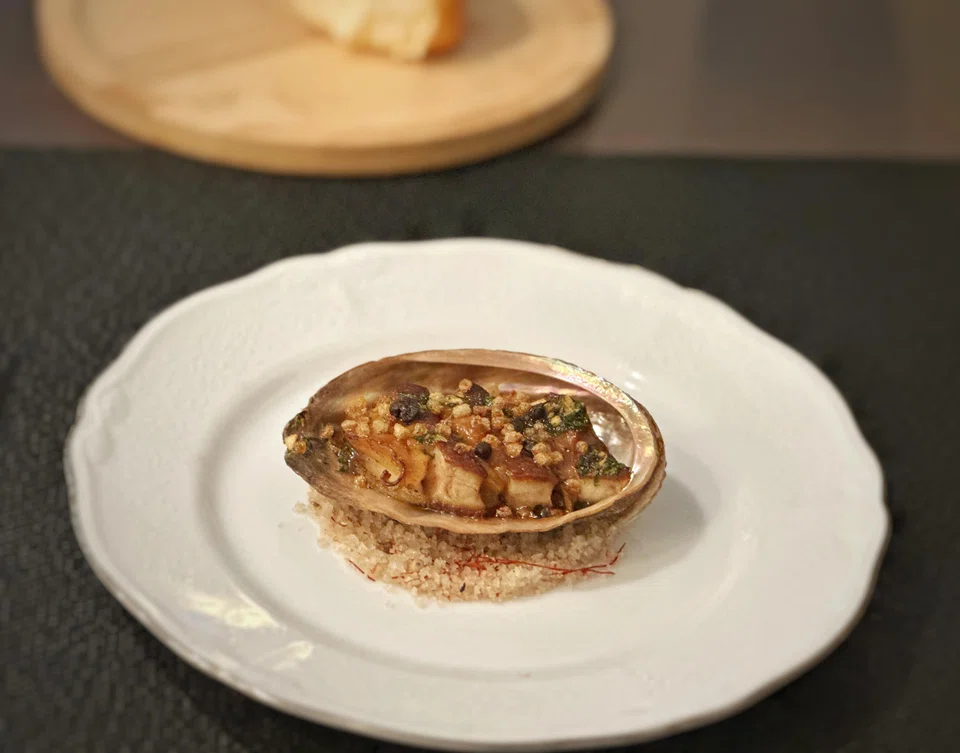 Korean abalone is layered with foie gras and lightly gratinated.