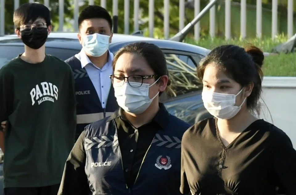 Pansuk Siriwipa (right) being escorted by the Singapore police at Woodlands Checkpoint on Aug 11, 2022. 