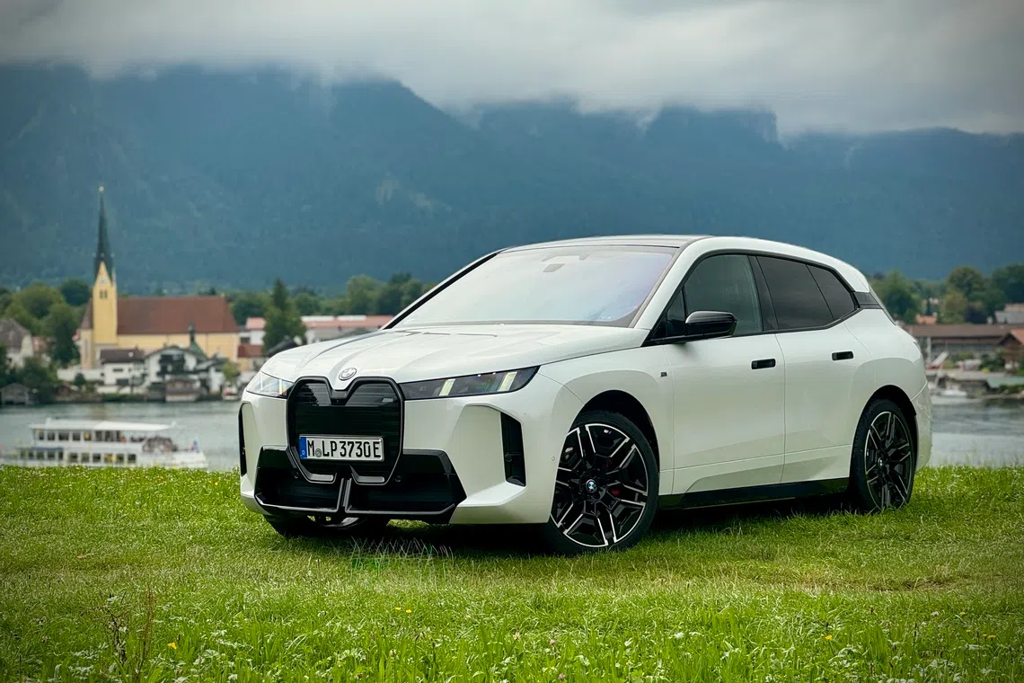 After a facelift, the BMW iX still looks mostly the same, with its slab-sided body and carbon shell, but the grille now lights up and the headlights look a bit sharper.