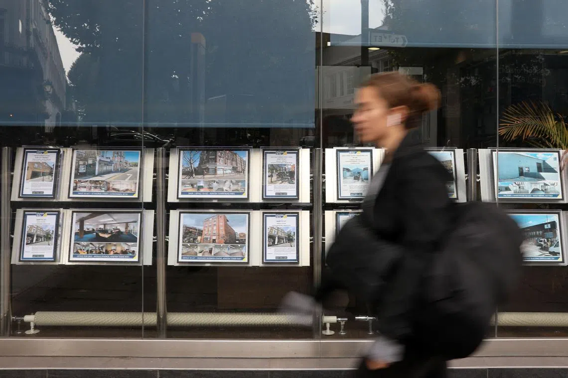 A pedestrian walks past resdiential properties displayed for sale in the of an estate agents' in London on September 30, 2022. - The plan for top-to-bottom tax cuts, financed by a borrowing spree, have unnerved financial markets, alienated the International Monetary Fund and caused tensions with the Bank of England (BoE). Most immediately for UK voters, it is driving up costs including for home mortgages, as market interest rates surge in the middle of the worst cost-of-living crisis in generations. (Photo by ISABEL INFANTES / AFP)