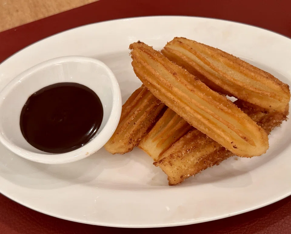 Crisp churros with chocolate sauce.