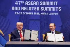US President Donald Trump and Malaysian Prime Minister Anwar Ibrahim hold up trade deal documents during a bilateral meeting during the 47th Asean summit in Kuala Lumpur.