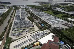 Vehicles waiting for shipment at a lot in a shipping terminal in Shanghai, China, July 25, 2024. US Treasury Secretary Janet Yellen said Beijing was channeling too much of its GDP into investment in advanced manufacturing that is flooding the world with cheap Chinese goods, adding that China’s economy was now too large to grow through that model.