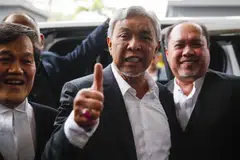 Deputy Prime Minister Ahmad Zahid Hamidi (centre) leads the scandal-tainted United Malays National Organisation that Anwar counts on to stay in power.