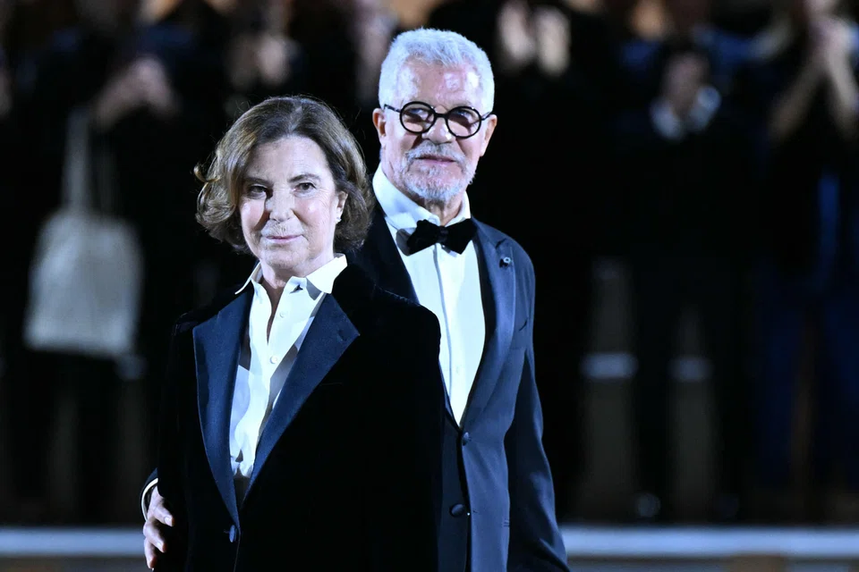 Silvana Armani, Armani's head of women’s design, and Leo Dell’Orco, its head of men’s design, greeting the audience at the end of the the fashion house's collection show at Milan Fashion Week.