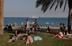 Tourists enjoying the weather at Malagueta beach, on a hot summer day, in Malaga, southern Spain, one of Europe’s top holiday destinations.