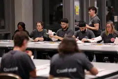 Staff counting ballot papers in London, Britain, July 4, 2024. As polling stations closed at 10.00 pm (2100 GMT), a survey for UK broadcasters suggested centre-left Labour would win 410 seats in the 650-seat House of Commons, with the right-wing Tories managing only 131.