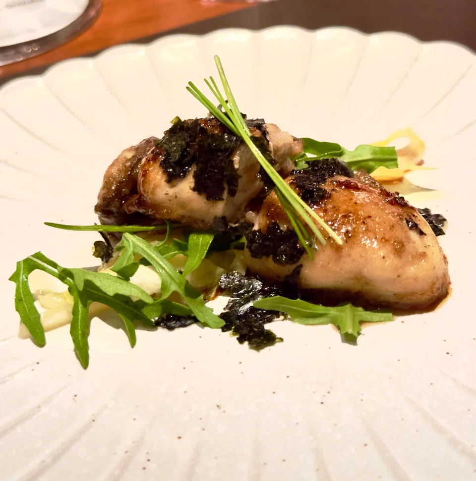 Oyster prepared with Worcestershire sauce and seaweed.