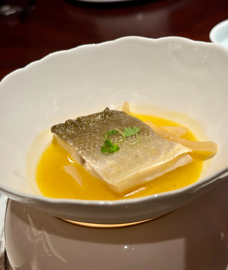 Poached threadfin in plum sauce.