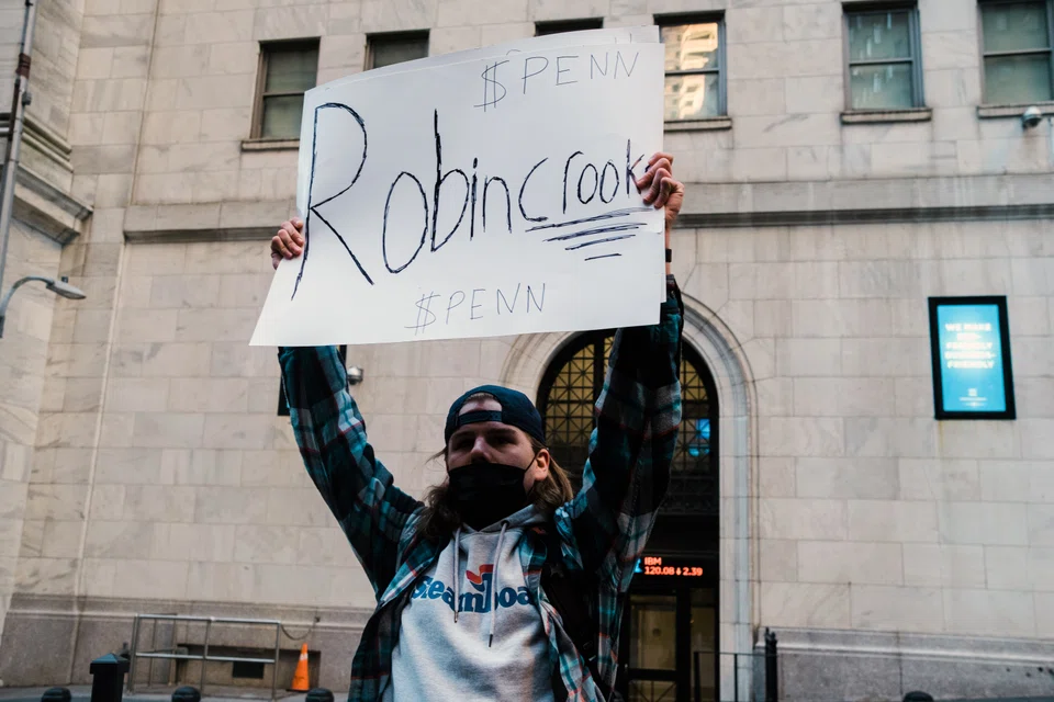 A protester on Robinhood's decision to impose trading limits on GameStop and other stocks in 2021.