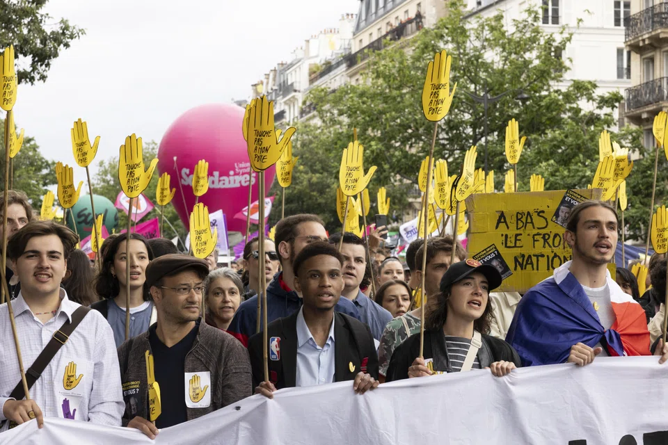 People at a demonstration against the far-right RN party, which is known for its anti-immigration stance.