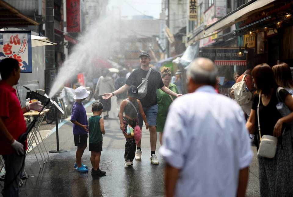 Tourists at Tsukiji Outer Market, a popular sightseeing spot, Tokyo, Japan, Aug 22, 2025.. The Japanese government issued a heatstroke alert in Tokyo and other prefectures.