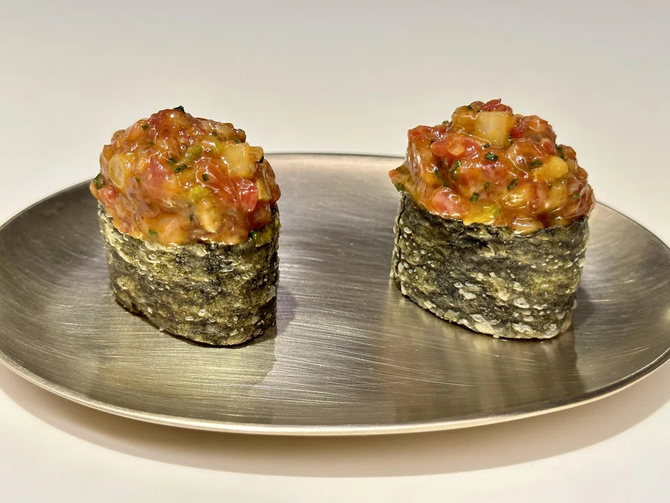 Beef tartare sits atop crispy seaweed-wrapped sushi rice.