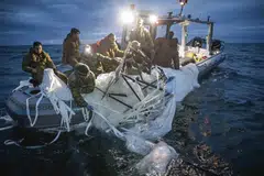 In a photo provided by the US Navy, sailors recover the downed Chinese surveillance balloon off the coast of South Carolina on Feb 5, 2023. 