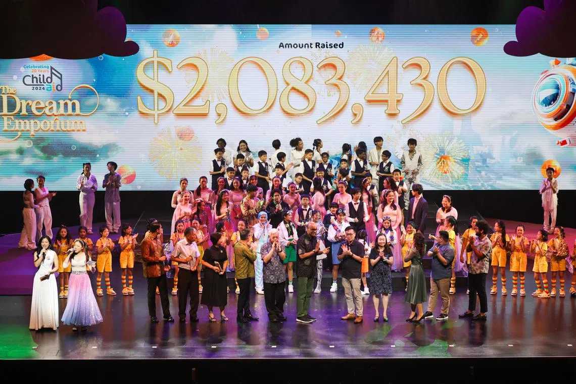 President Tharman Shanmugaratnam (centre, black patterned shirt), with the main sponsors of ChildAid 2024 and SPH Media representatives, celebrating the funds raised for disadvantaged children.