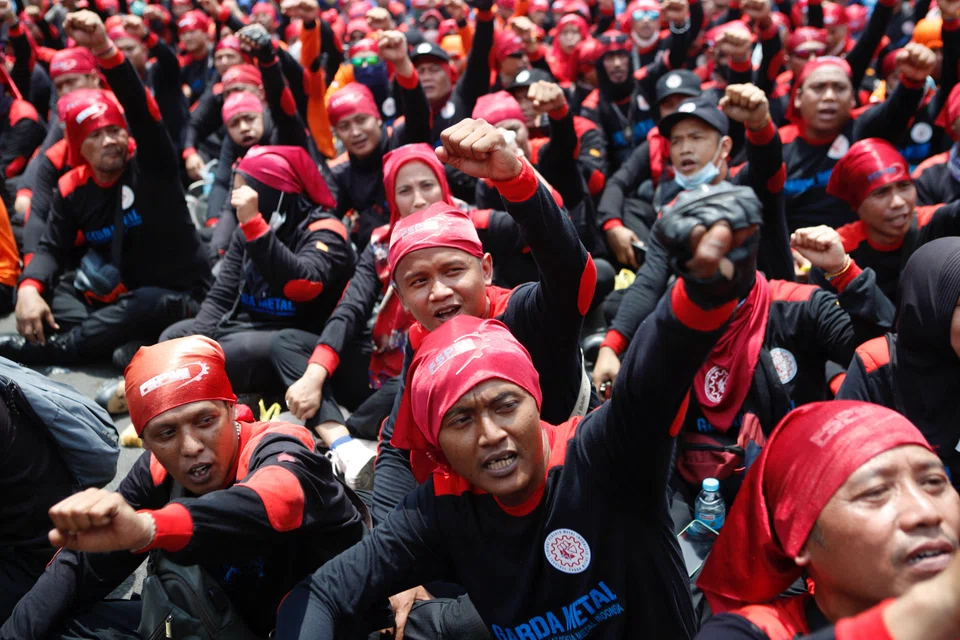 Members of Indonesian labour organisations protest against the government outside Parliament on Tuesday following its decision to raise subsidised fuel prices.