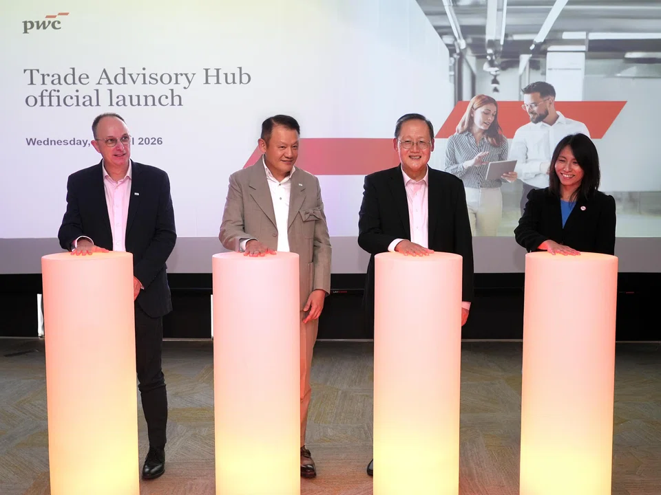 From left: PwC Singapore's Trade Advisory Hub leader Frank Debets and executive chairman Marcus Lam; Minister for Manpower Dr Tan See Leng; and EDB's executive vice-president Ho Weng Si.