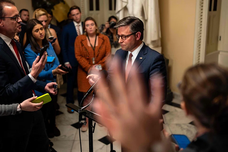 US House Speaker Mike Johnson talks to reporters following a vote on a stopgap government funding bill at the Capitol, Washington, DC, Sept 25, 2024.