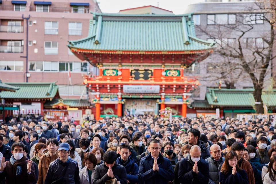 Visitors offering prayers on the first business day of the year at the Kanda Myojin shrine in Tokyo on Jan 4. There are reasons to be optimistic about investing in Japan, including corporate governance reforms and cheap money.