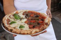 The classic Marseille slice is the moitie-moitie (half-half), a tomato-based pie with anchovies on one side and cheese on the other.