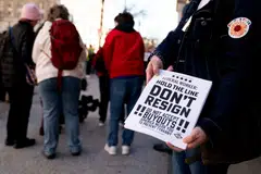 A demonstrator holds fliers encouraging federal workers not to resign during a protest against Elon Musk outside the US Treasury building in Washington, DC, Feb. 4, 2025. The US Treasury Department confirmed Tuesday that Elon Musk’s government efficiency team has been given “read-only” access to “coded data” of the government’s payments system. 
