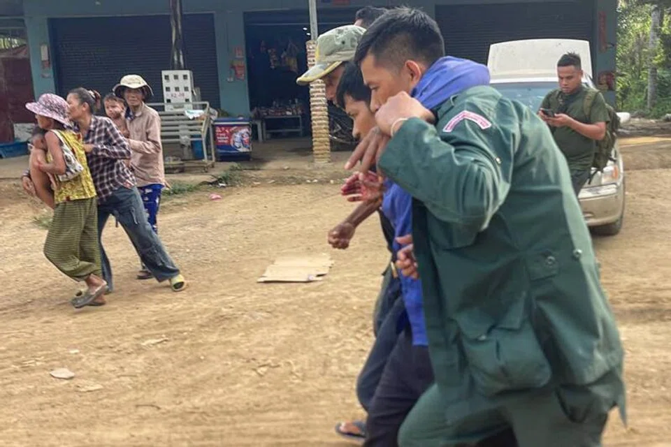An injured Cambodian being helped after Cambodia and Thailand traded accusations of fresh clashes along their border. 