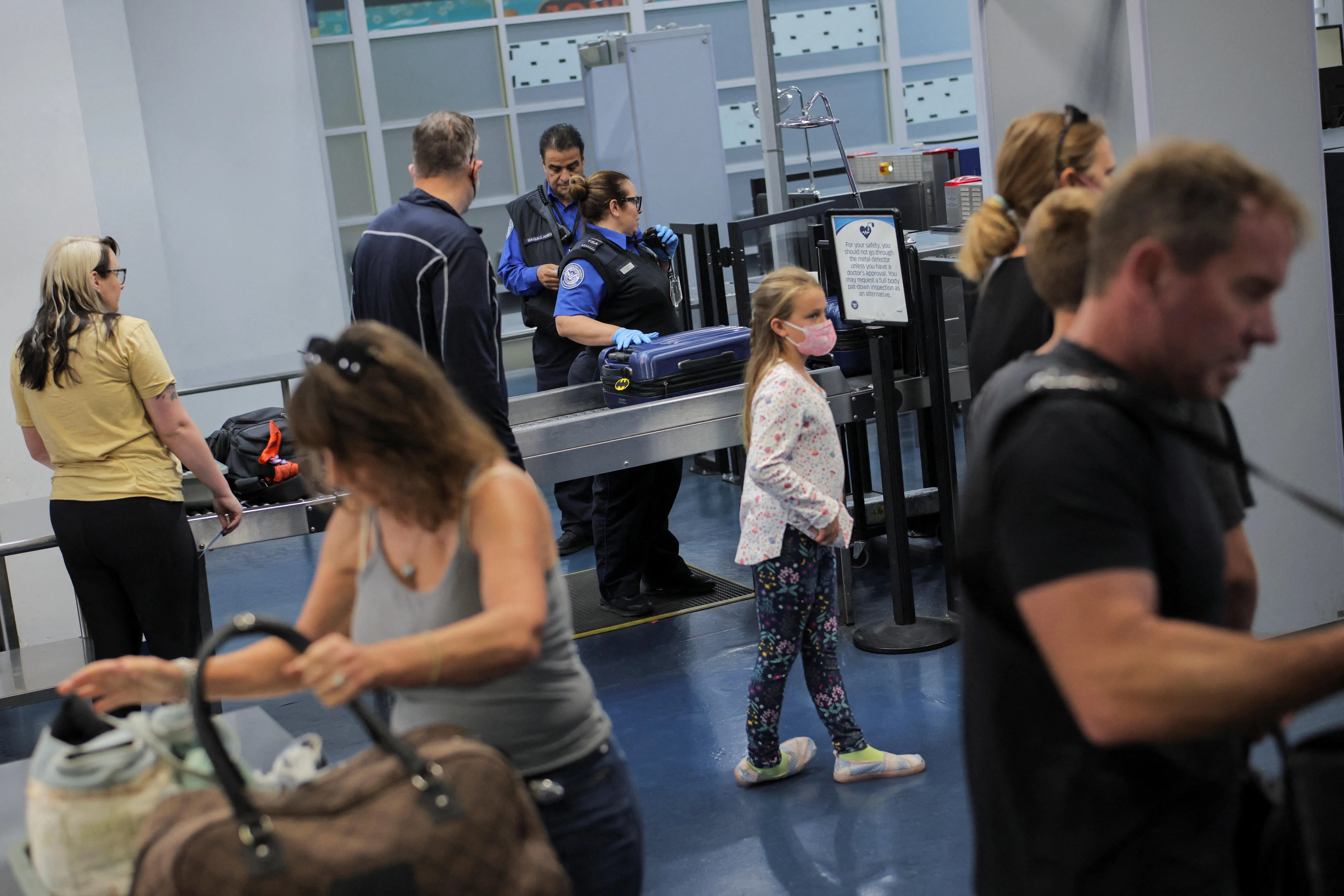 Travellers pass through a Transportation Security Administration (TSA) security screening at Hollywood Burbank Airport during the first day of a partial US government shutdown in Burbank, California, Oct 1, 2025. The airport, which connects Los Angeles to the rest of the country, was set to be without qualified staff in the control tower for around six hours, Governor Gavin Newsom said.