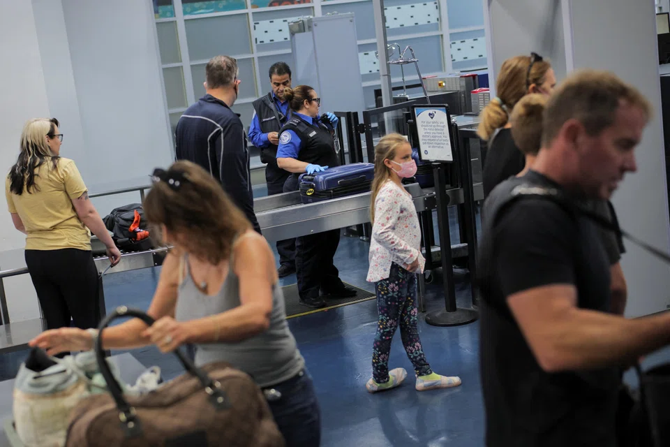 Travellers pass through a Transportation Security Administration (TSA) security screening at Hollywood Burbank Airport during the first day of a partial US government shutdown in Burbank, California, Oct 1, 2025. The airport, which connects Los Angeles to the rest of the country, was set to be without qualified staff in the control tower for around six hours, Governor Gavin Newsom said.