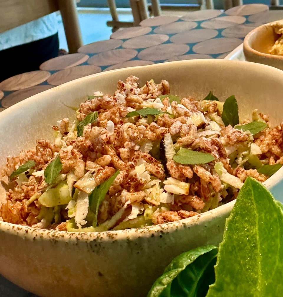 Grilled squid salad with vegetables in a pesto-like dressing.