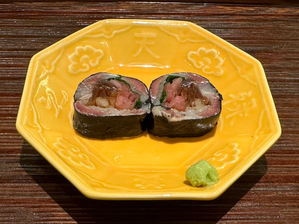 Vibrant maki of sardines, pickled turnip and shiso leaves wrapped in nori.