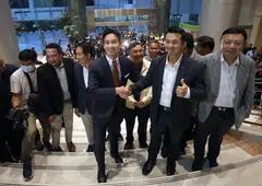Move Forward Party's leader and its prime ministerial candidate Pita Limjaroenrat (centre) shake hands with Pheu Thai Party leader Cholnan Srikaew as the eight-party coalition reaffirmed its backing for Pita to become prime minister.