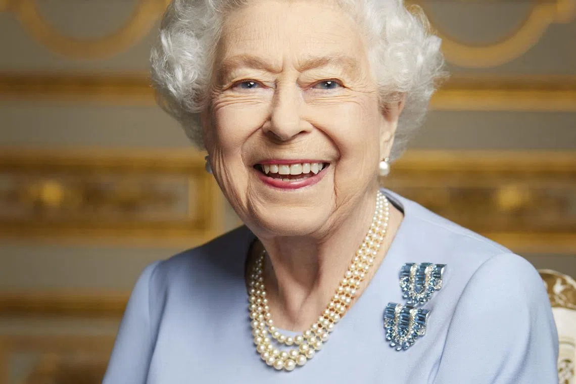 A new  image released by Buckingham Palace on September 18, 2022, shows Britain's Queen Elizabeth II smiling, photographed at Windsor Castle in May 2022. Huge crowds built in central London from early morning on September 19, 2022, to secure a spot to watch the state funeral of Queen Elizabeth II at Westminster Abbey. 