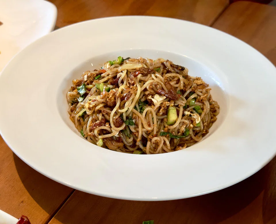 The springy fried noodles with spicy sausage and Hunan bacon.