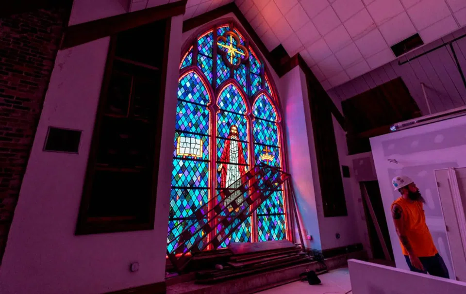 Workers in Columbia, South Carolina, transform the former Rosewood Baptist Church in three apartment buildings in 2022. 