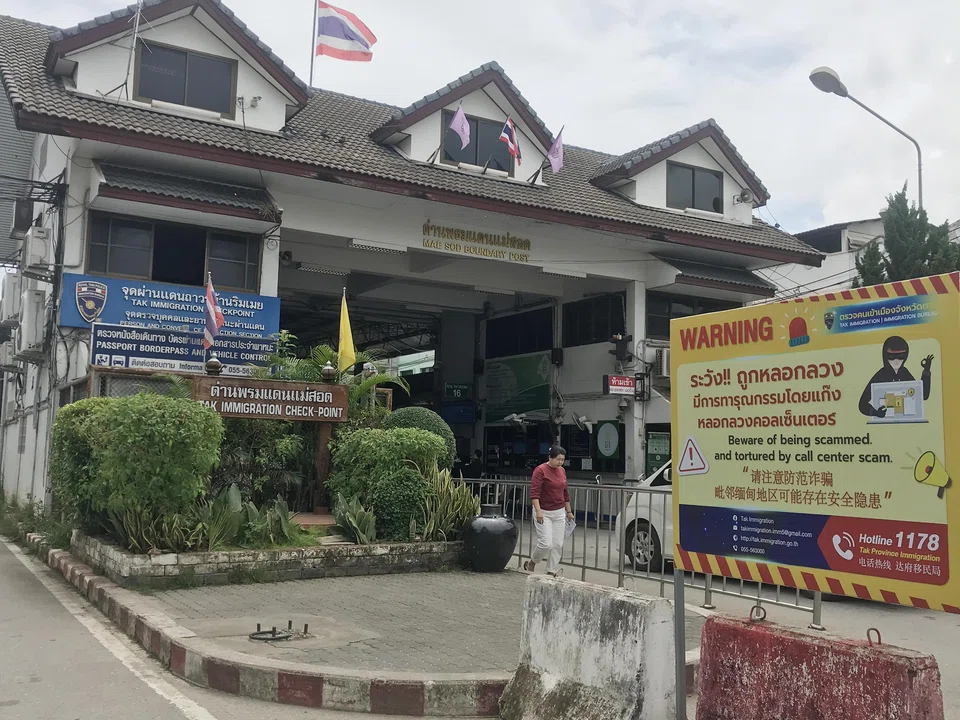 A scam awareness poster at the immigration checkpoint between Thailand and Myanmar in the Thai border town of Mae Sot. The breadth of the industry stretches far and wide, stemming from forced labour gulags in the grey-zone borderlands of South-east Asia.