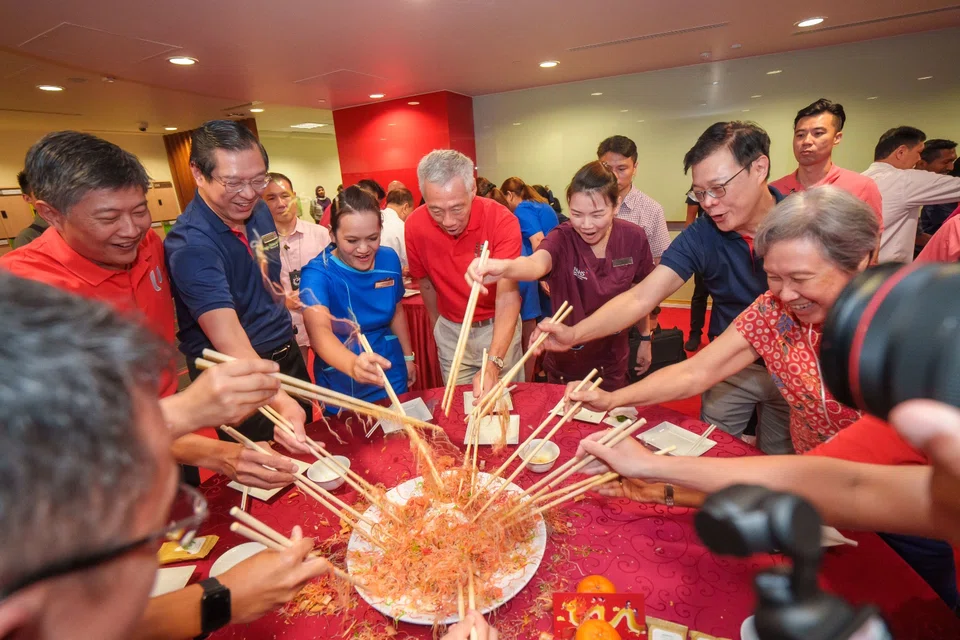 Prime Minister Lee Hsien Loong joining staff from Ng Teng Fong General Hospital for Chinese New Year celebrations on Friday, during his annual visit to workers. 